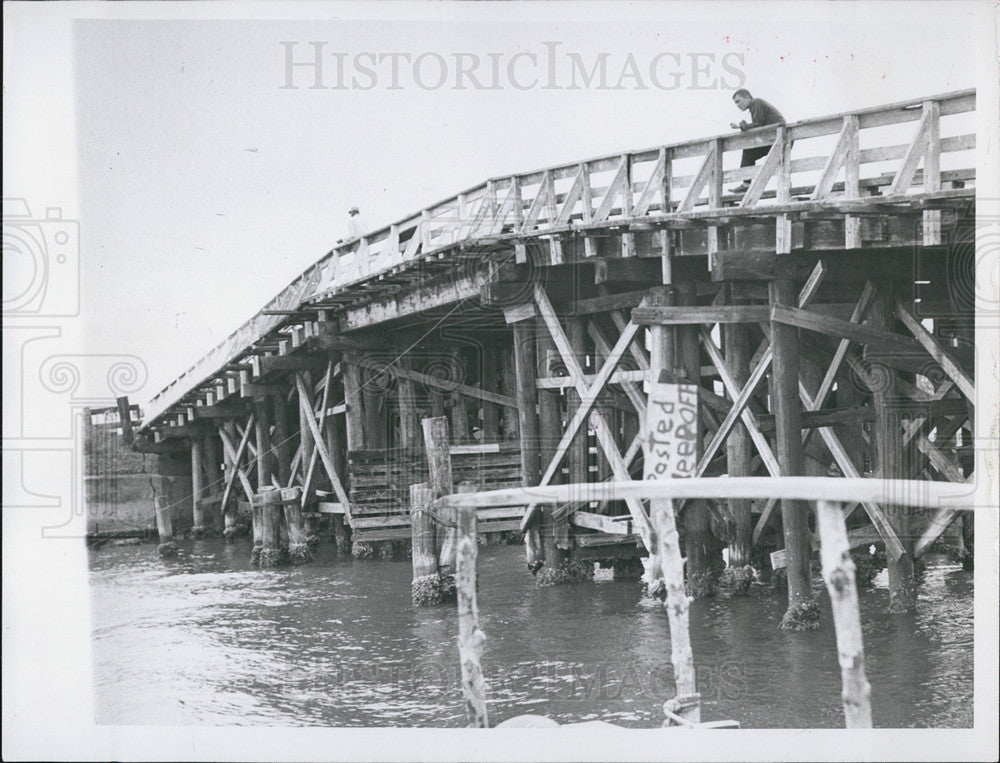 1957 Press Photo Man Takes Break on Humpback Bridge - Historic Images