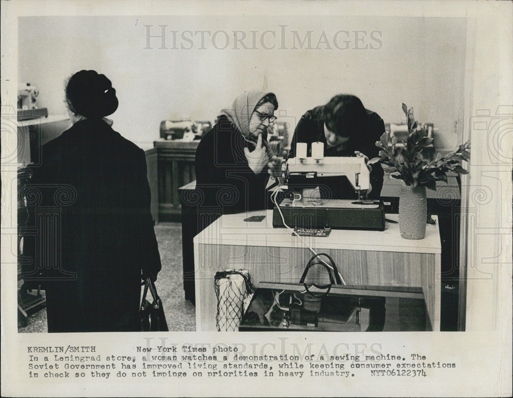 Press Photo Woman Watches Sewing Machine Demonstration In Leningrad Soviet Union - Historic Images