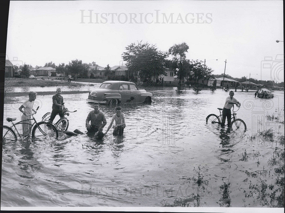 1958 Press Photo Children Play On Bicycles In Flooded 32nd Avenue In Denver, CO - Historic Images