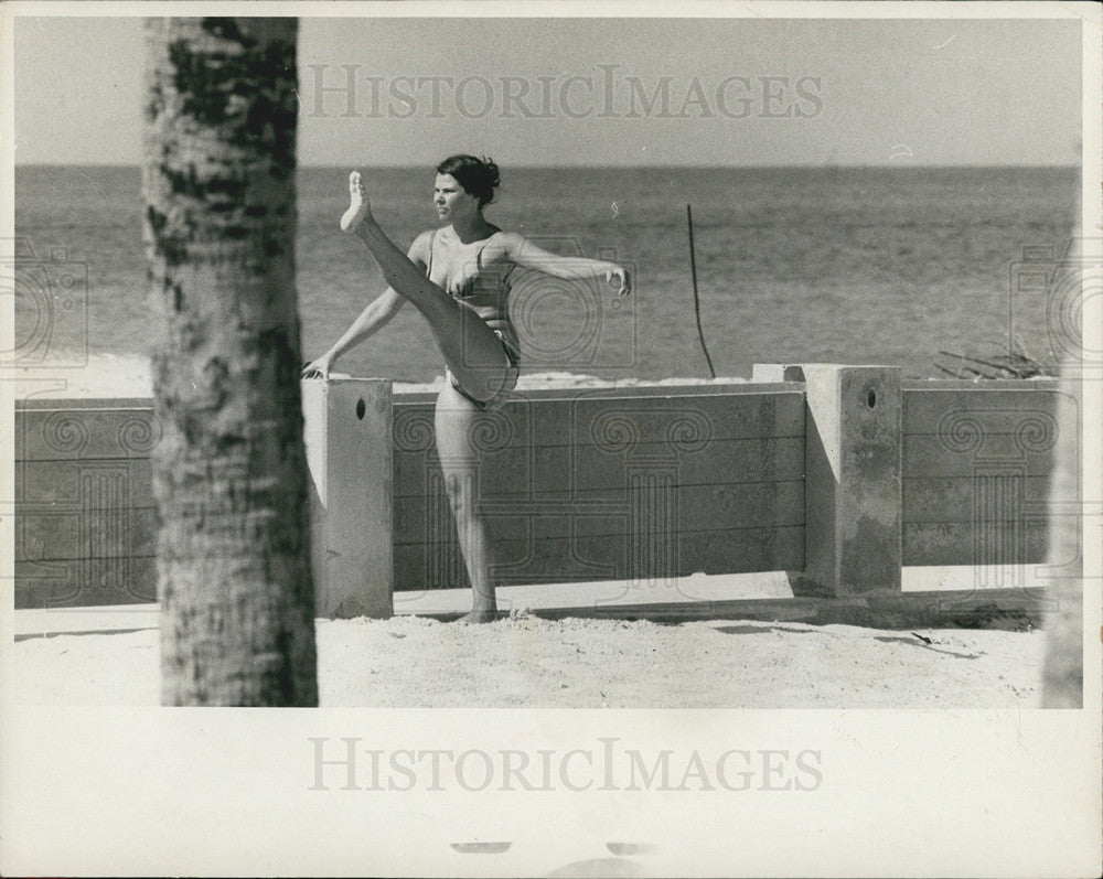 1971 Press Photo A woman stretching on the beach - Historic Images