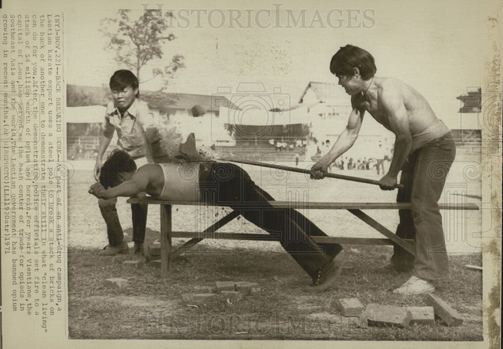 1971 Press Photo Laotian Karate Expert Breaking Bricks On Man's Back Anti-Drug - Historic Images