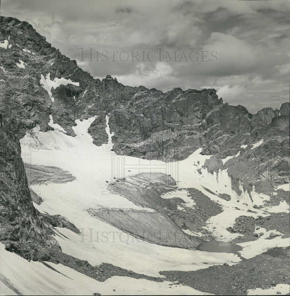 Press Photo mountain range partially covered in snow - Historic Images