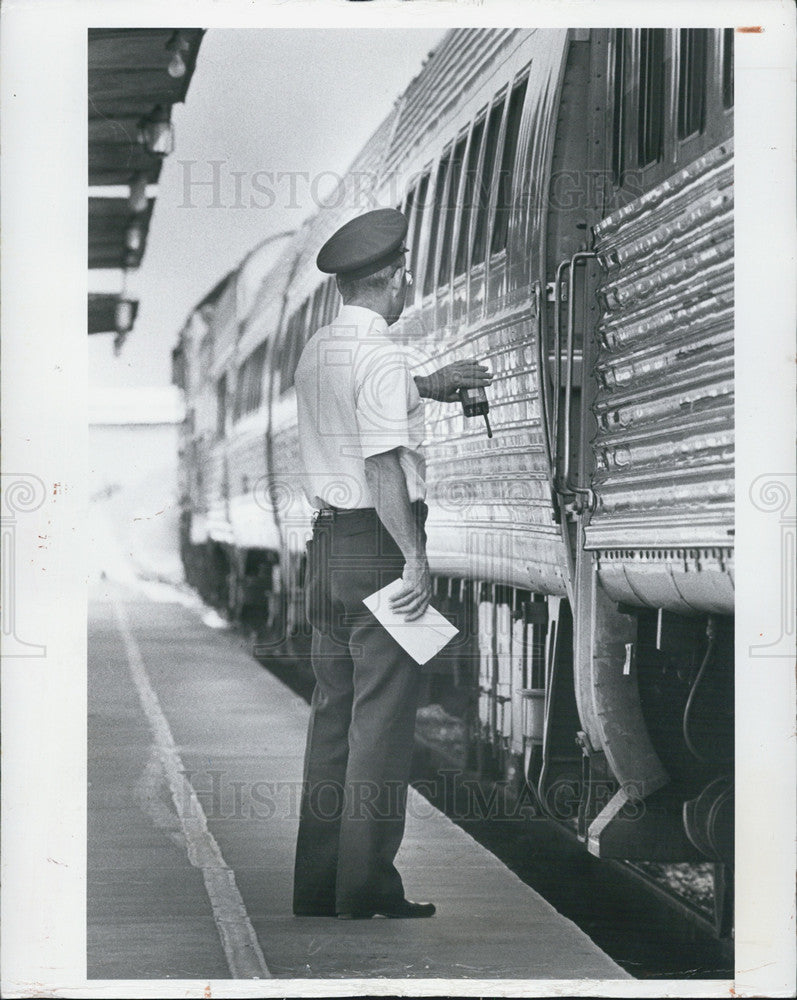 1983 Press Photo Conductor J.D. Sangster checks for an on-time departure to St. - Historic Images