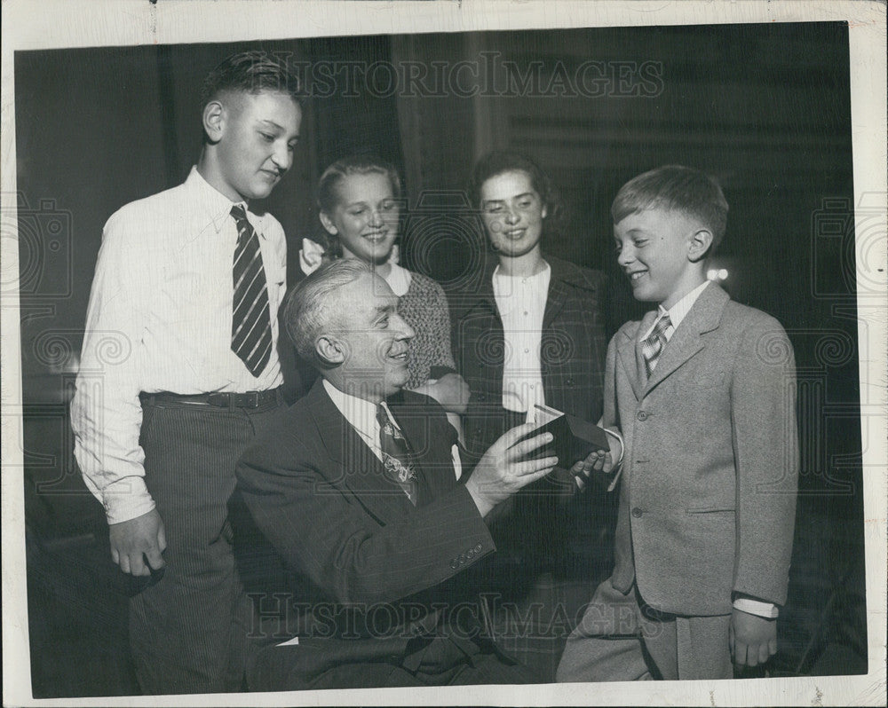 1947 Press Photo Robert Keenan Admires watch won by Douglas Maurer, champion of - Historic Images