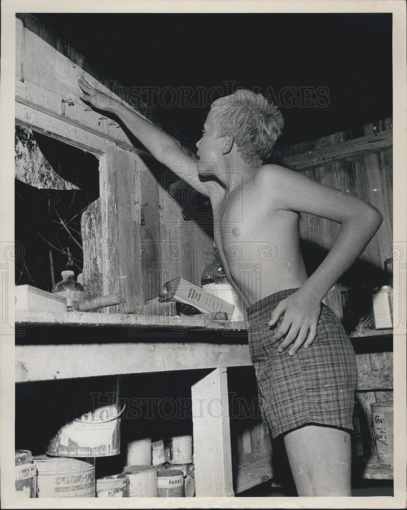 1963 Press Photo Steven Smith Inspects Roof Of Storage Shack After Waterspout - Historic Images