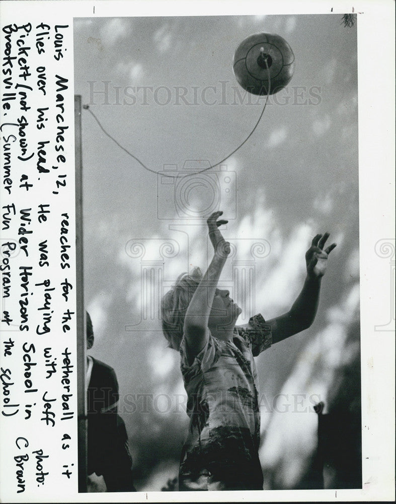 1965 Press Photo Louis Marchese reaches for tetherball - Historic Images