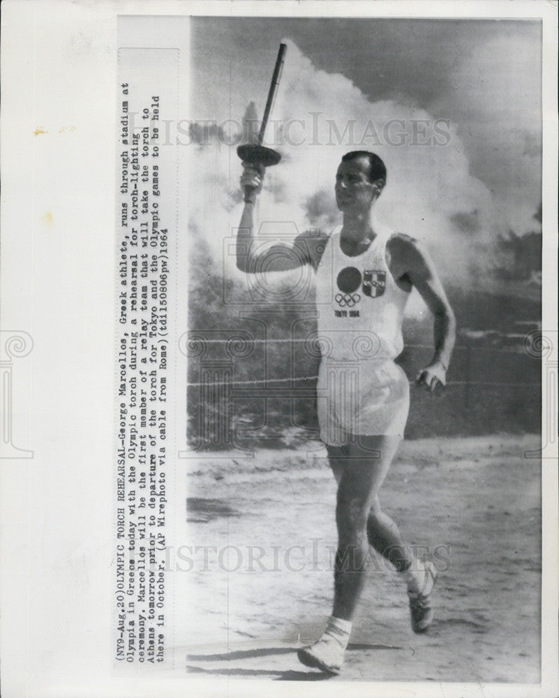 1964 Press Photo George Marcellos practices for torch-lighting ceremony - Historic Images