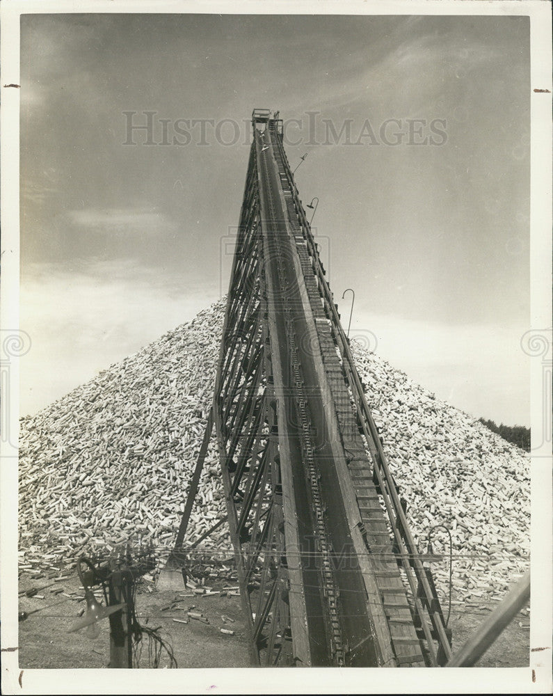 1942 Press Photo Surplus wood is being piled for processing in the winter. - Historic Images