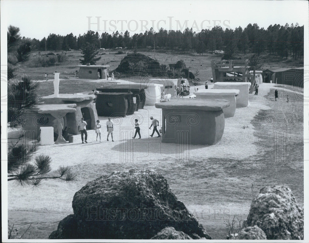 1966 Press Photo People walking around mock prehistoric village - Historic Images