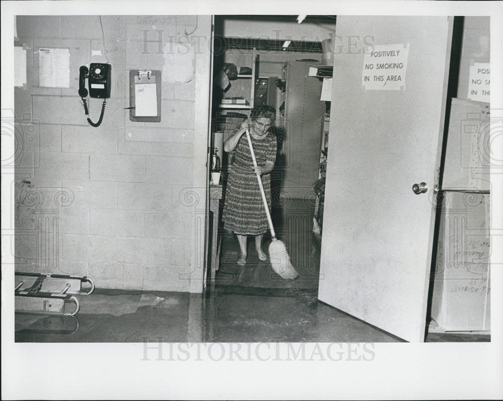 1966 Press Photo Marie Loos Sweeps Water from Montgomery Ward - Historic Images