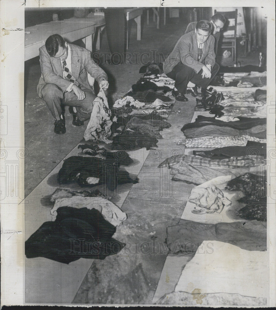 1949 Press Photo Investigators inspect the clothes of S.S. Noronic fire victims - Historic Images