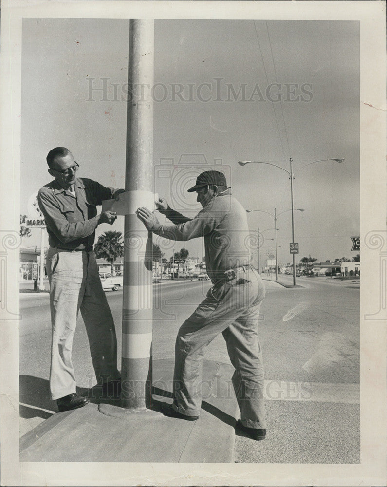 1964 Press Photo Getting ready to move light poles due to car accidents - Historic Images