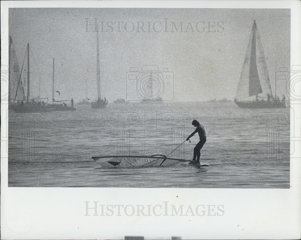1976 Press Photo Kid on surfboard among sailboats - Historic Images