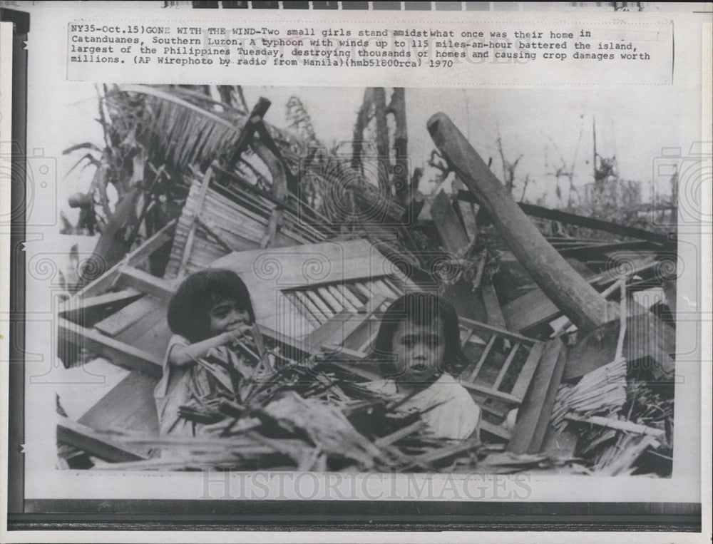 1970 Press Photo Two girls among ruins of home after Typhoon in Luzon - Historic Images
