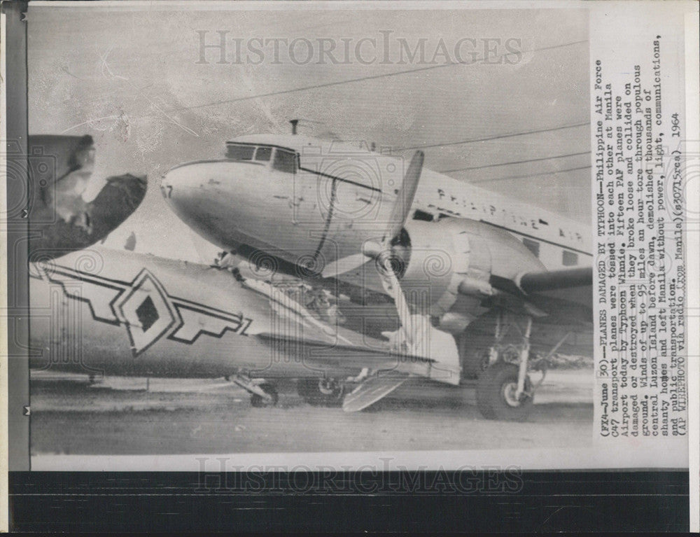 1964 Press Photo Two Philippine Air Force planes tossed by Typhoon Winnie - Historic Images