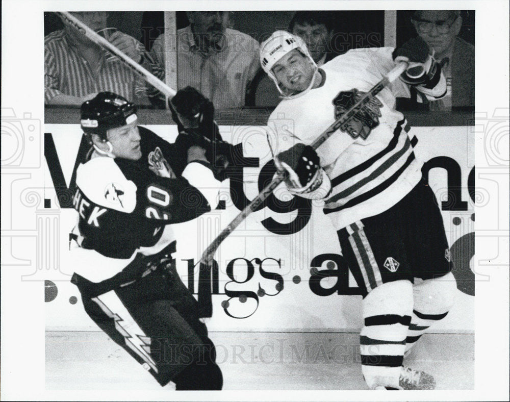 1994 Press Photo Rich Sutter is knocked off Balance by Rudy Poeschek. - Historic Images