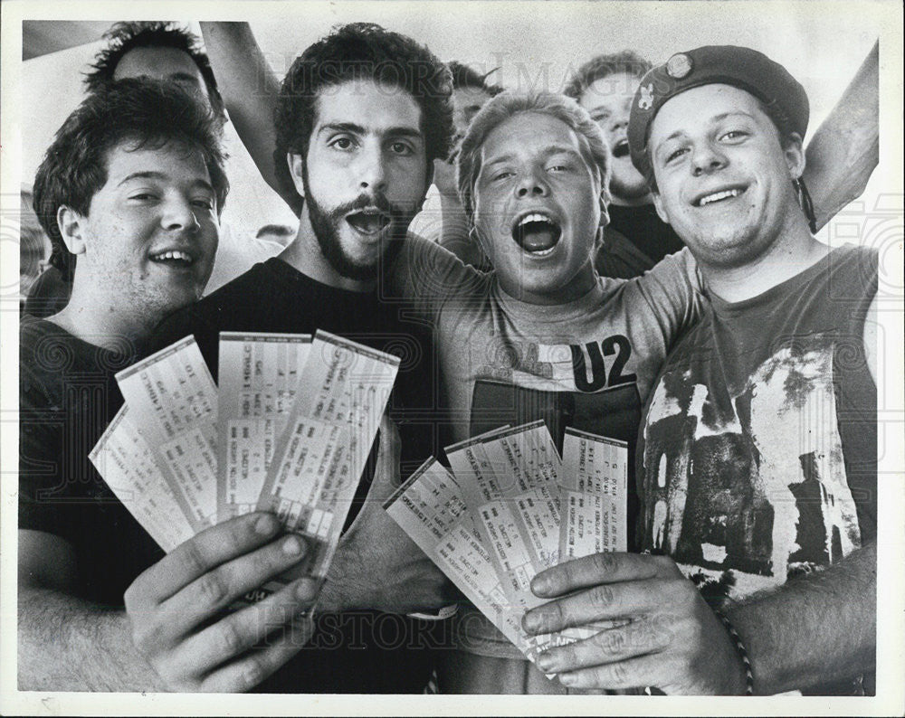 1987 Press Photo Fans Hold U2 Boston Concert Tickets - Historic Images