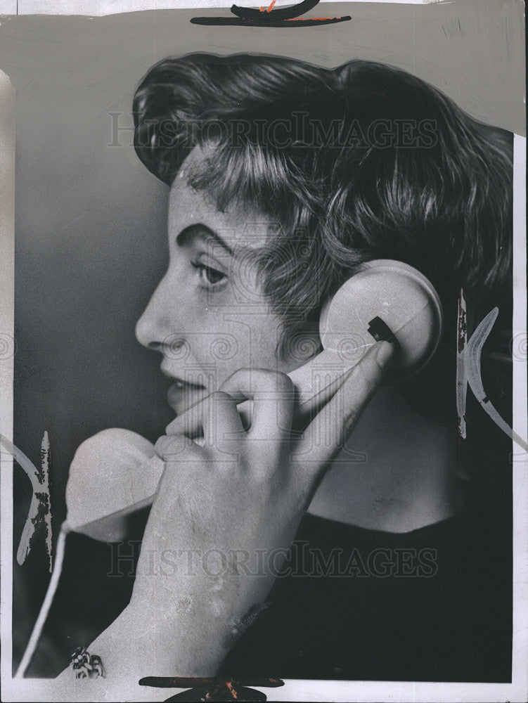 1957 Press Photo Woman with finger on amplifier switch on phone handset - Historic Images