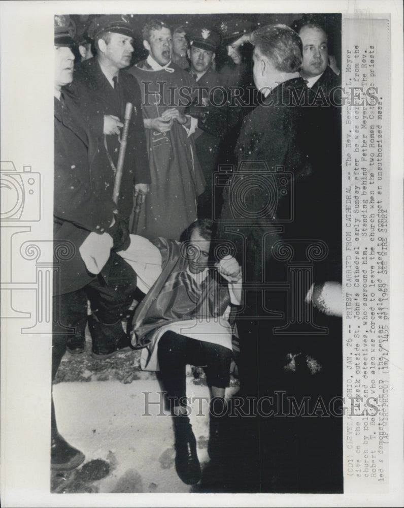 1969 Press Photo Rev. Bernard L Meyer sits on sidewalk after police detained him - Historic Images