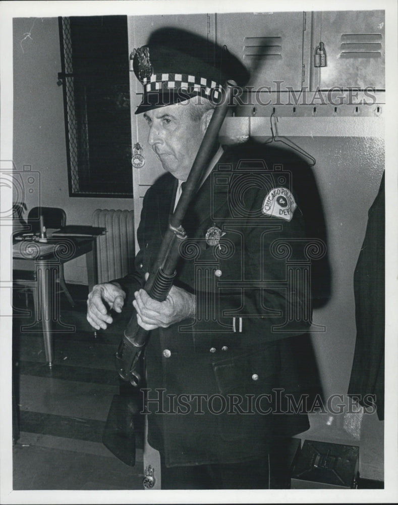 1968 Patrolman James Quinn, holds gun that killed Penny Ziv. - Historic Images