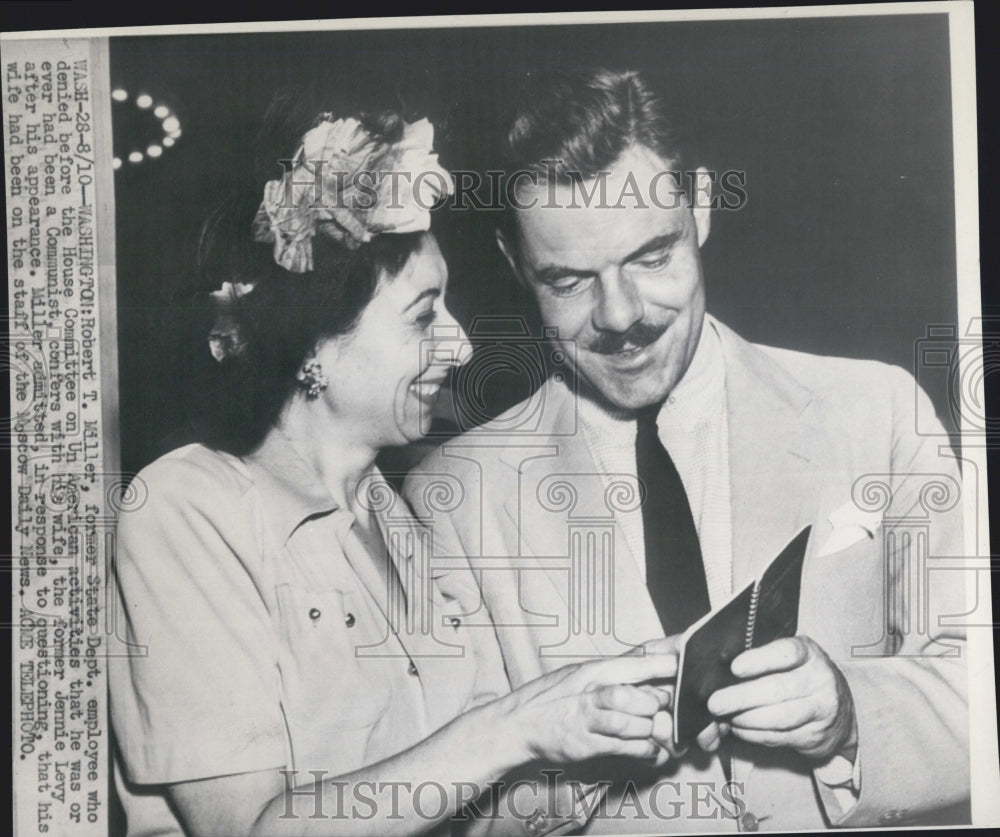 1948 Robert T. Miller confers with his wife after appearance - Historic Images