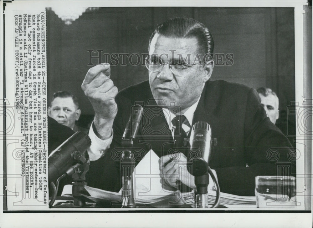 1966 Sec. of Def. Robert McNamara in front of microphones - Historic Images