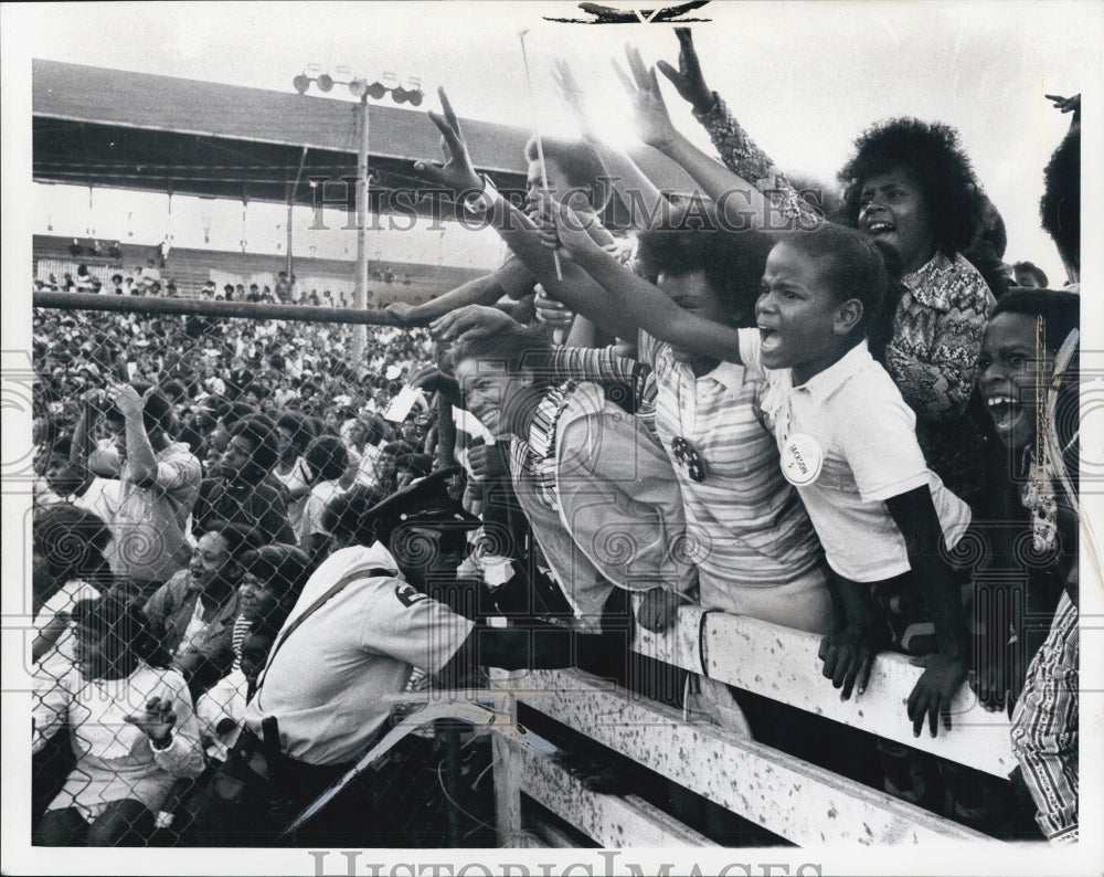 1971 Guards holding back excited children during Mich State Fair - Historic Images