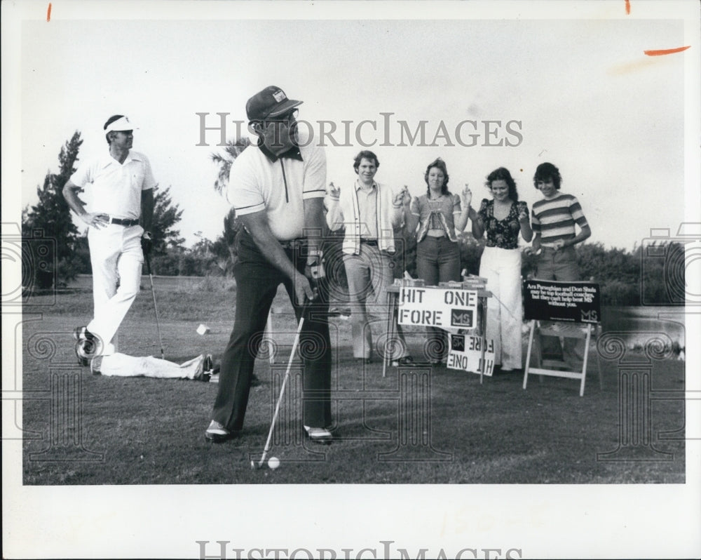 1975 Multiple Sclerosis teeing off for charity - Historic Images