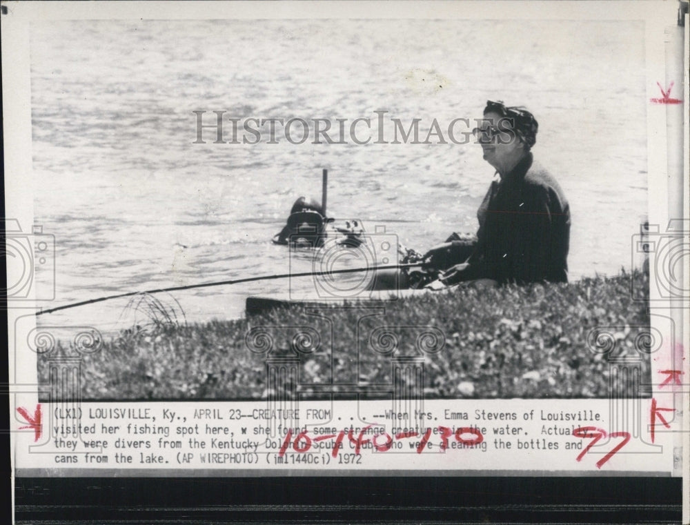 1972 Mrs Emma Stevens fishing at favorite spot with divers around - Historic Images