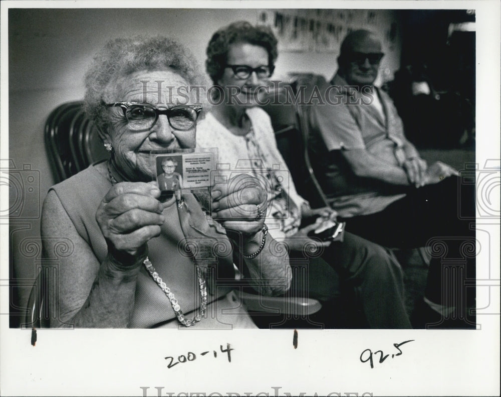 1967 Helen Young shows off her new senior citizen card - Historic Images