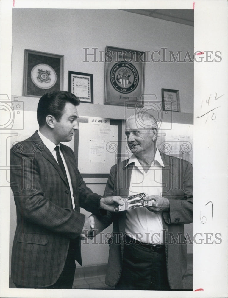 1968 Sports Staffer Bill Robinson giving tickets to Claude C. Woods - Historic Images