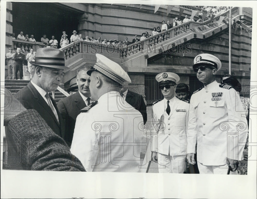 Press Photo Captain of a ship talking to people on land - Historic Images