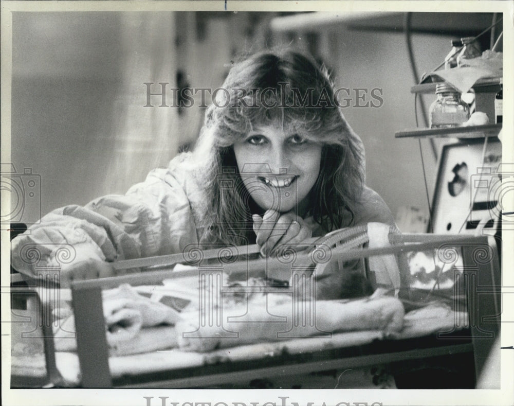 1986 Press Photo Tammy Martin smile over her son James. - Historic Images