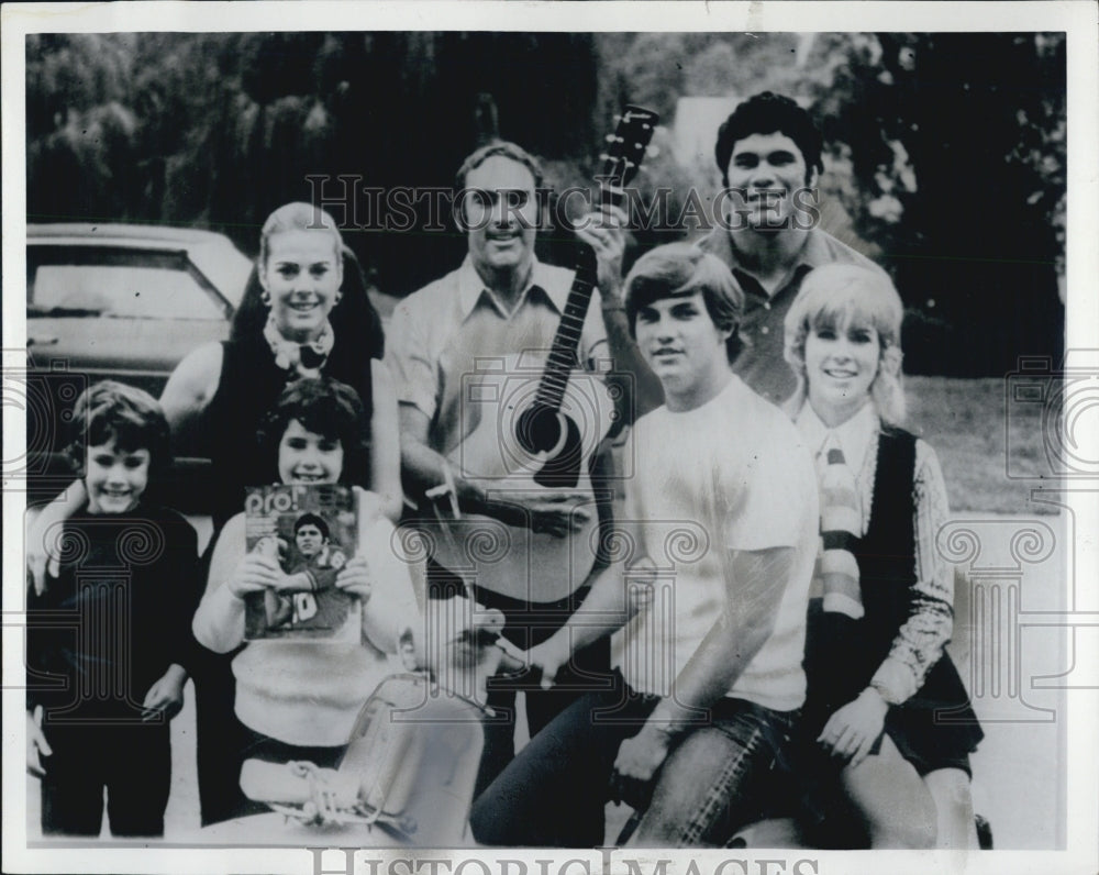 1976 Bob Woolf Holding Guitar With Family - Historic Images