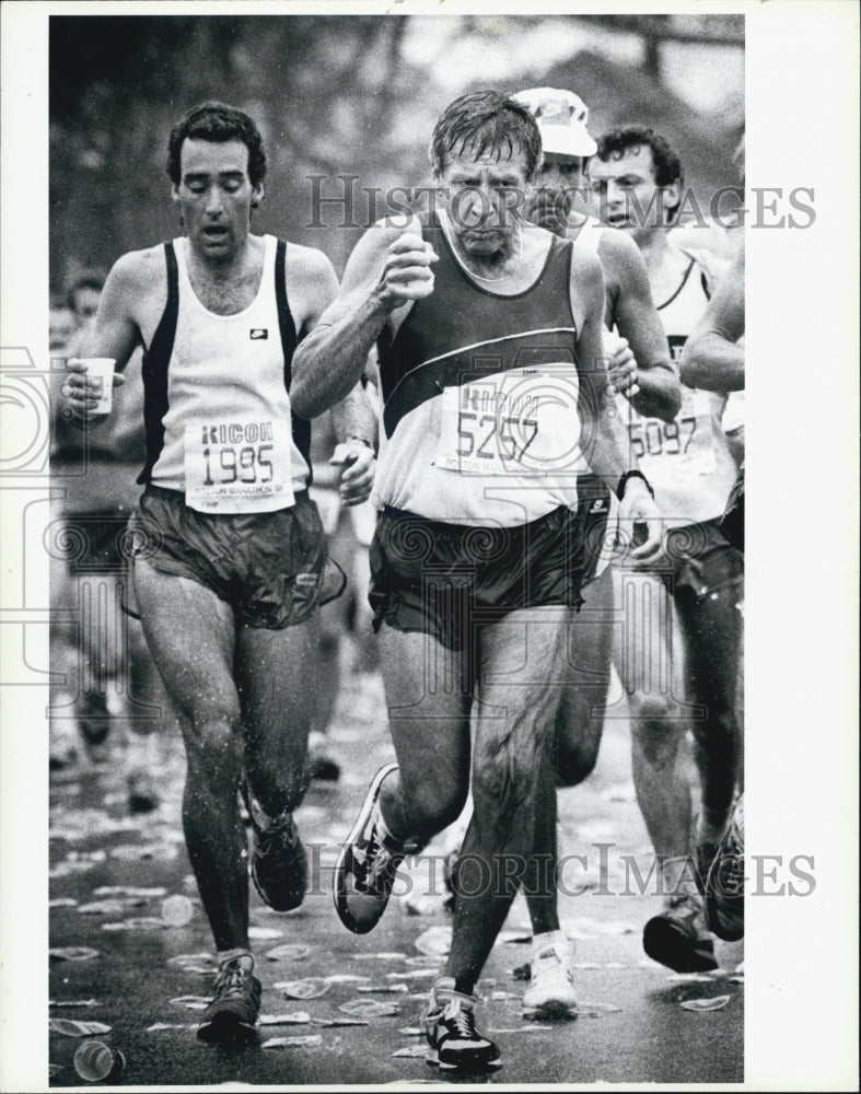 1988 Press Photo Boston Marathon Runners Holding Water Cups - Historic Images