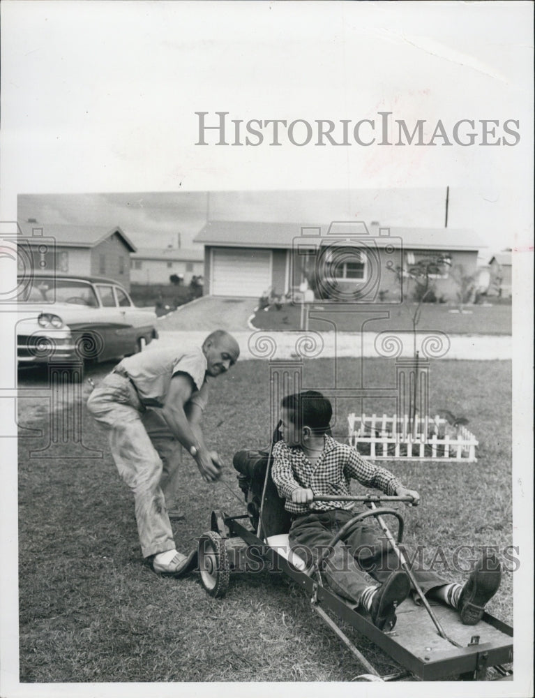 1959 Max Wander Syde and kids with home-made vehicles - Historic Images