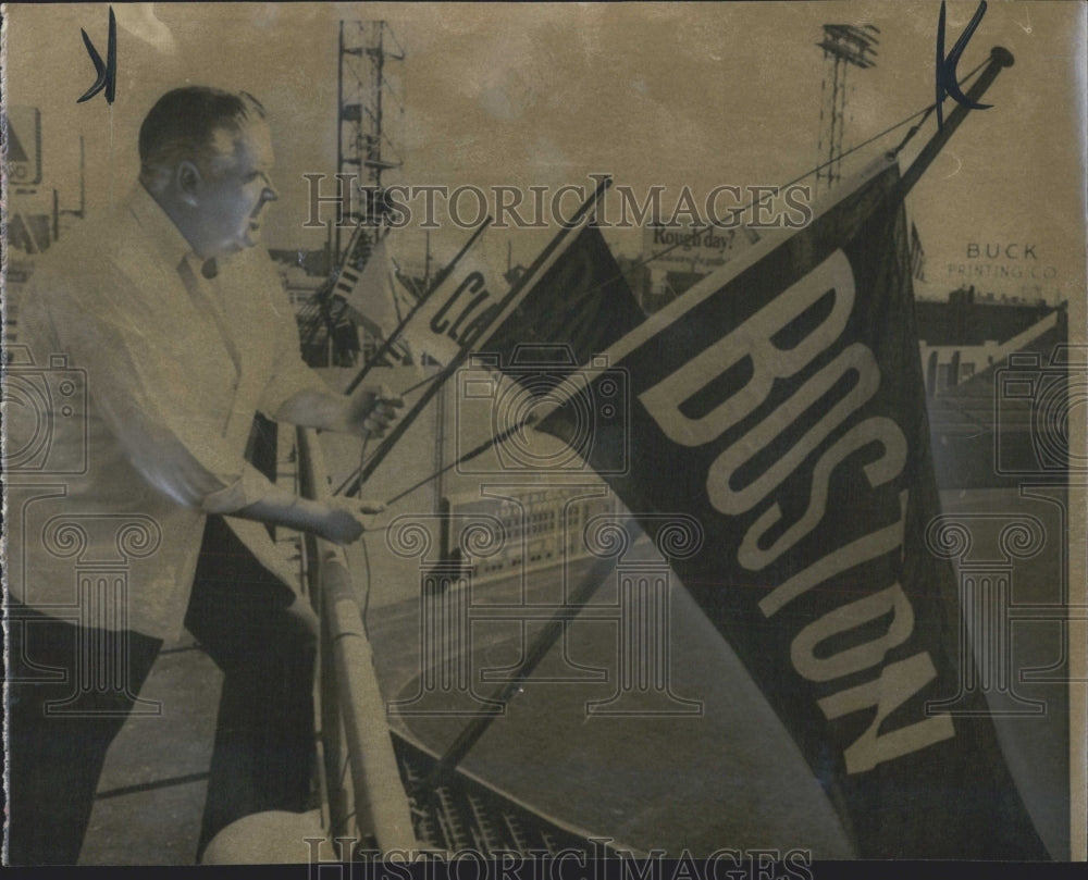 1966 Matty Duran shaking the mothballs out of american League flag - Historic Images