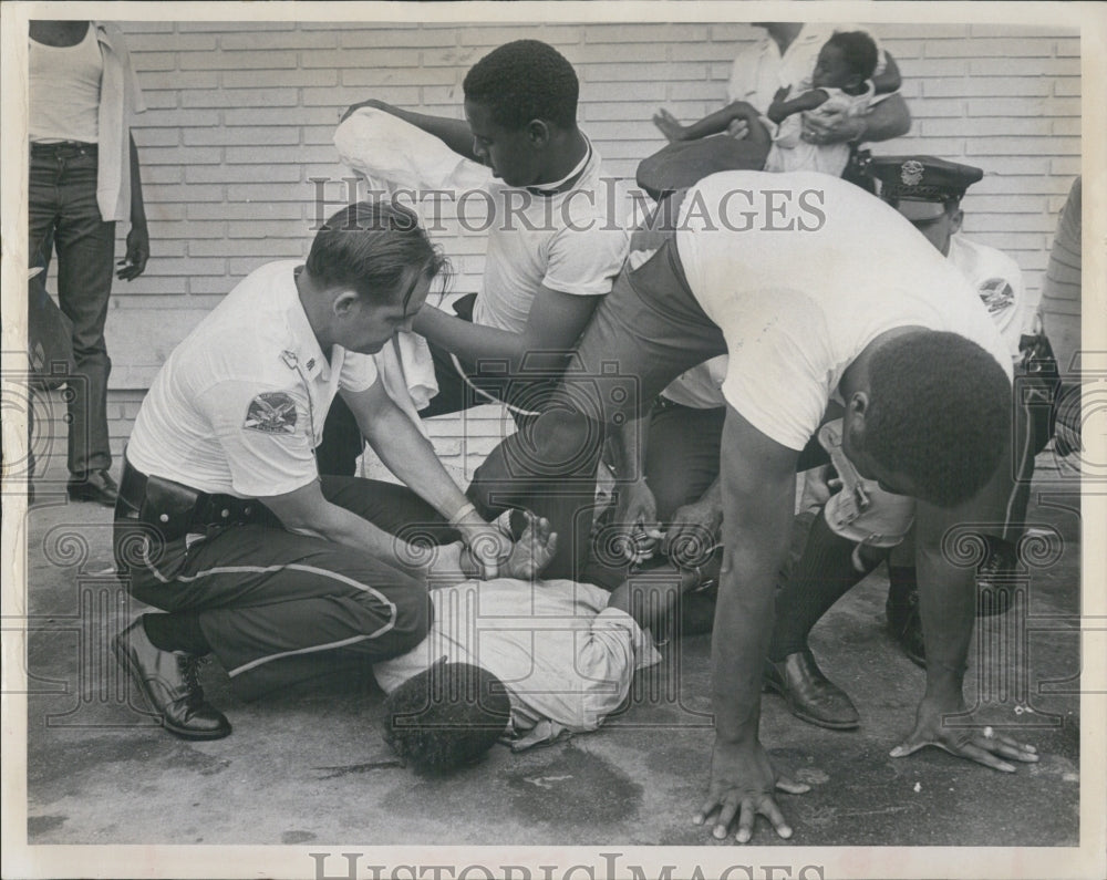 1966 Five charges follow struggle to arrest Patrick James. - Historic Images