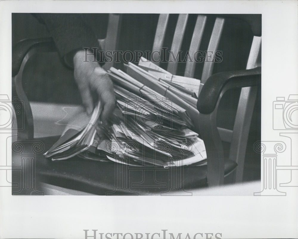 Press Photo chair with letters on it with person sorting - Historic Images