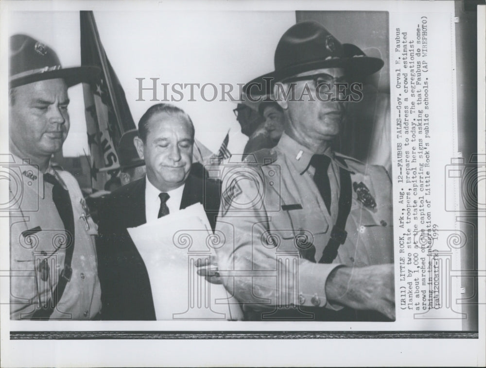 1959 Orval E. Faubus flanked by two state troopers. - Historic Images