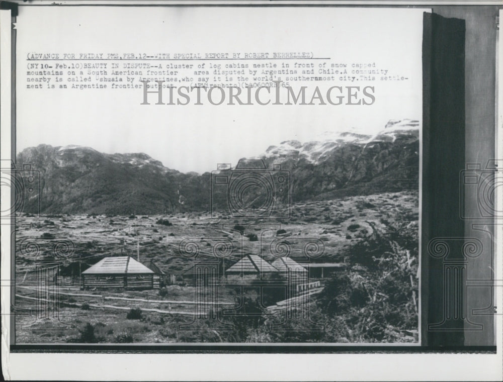 1965 Cluster of Log Cabins Front of Snow Capped Mountains - Historic Images