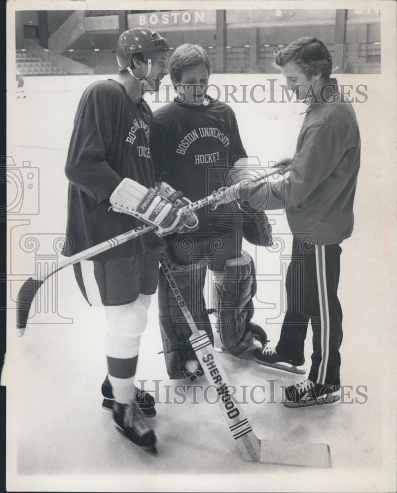 Press Photo 3 men playing in the ice rink. - Historic Images