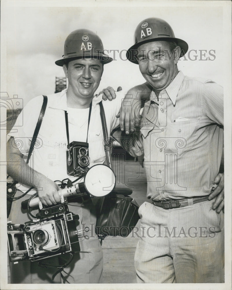 Press Photo George Trabant Takes Pictures Of Two Men In AB USS Hard Hats - Historic Images