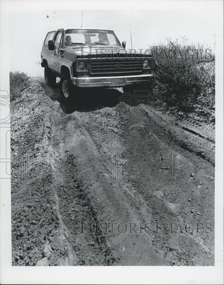 1976 4 Wheeler Chevy Bronco Cruises Over Dirt Terrain - Historic Images