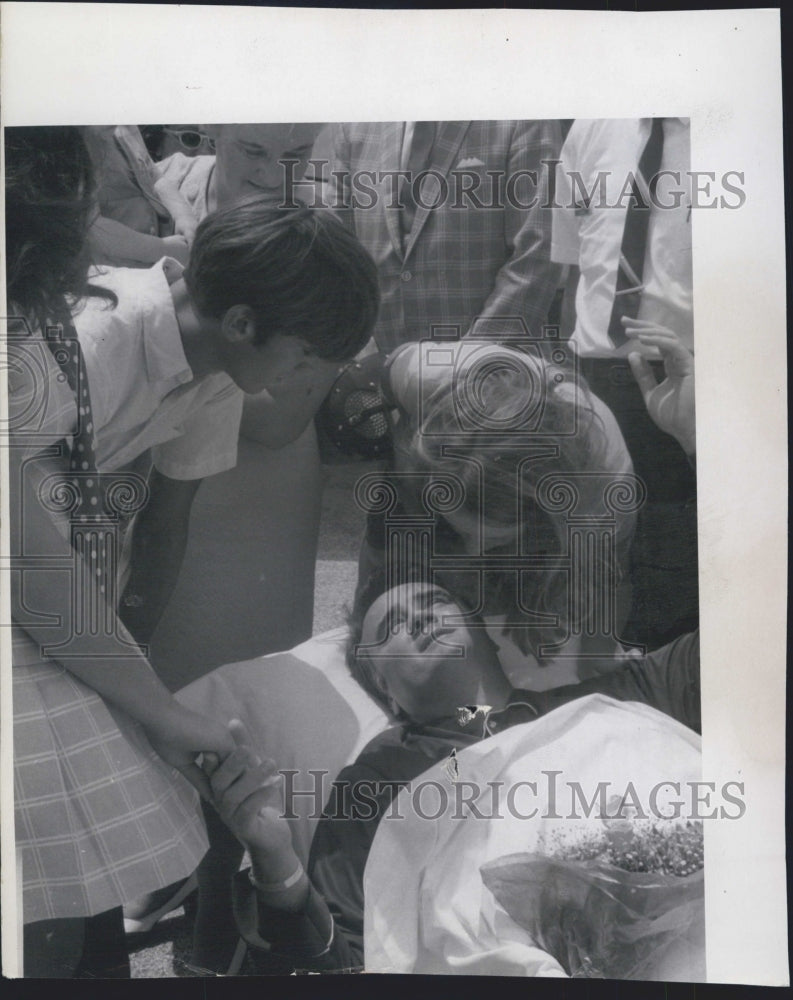 1970 Press Photo Family Greeted Young At Airport On Stretcher - RSG45455 - Historic Images