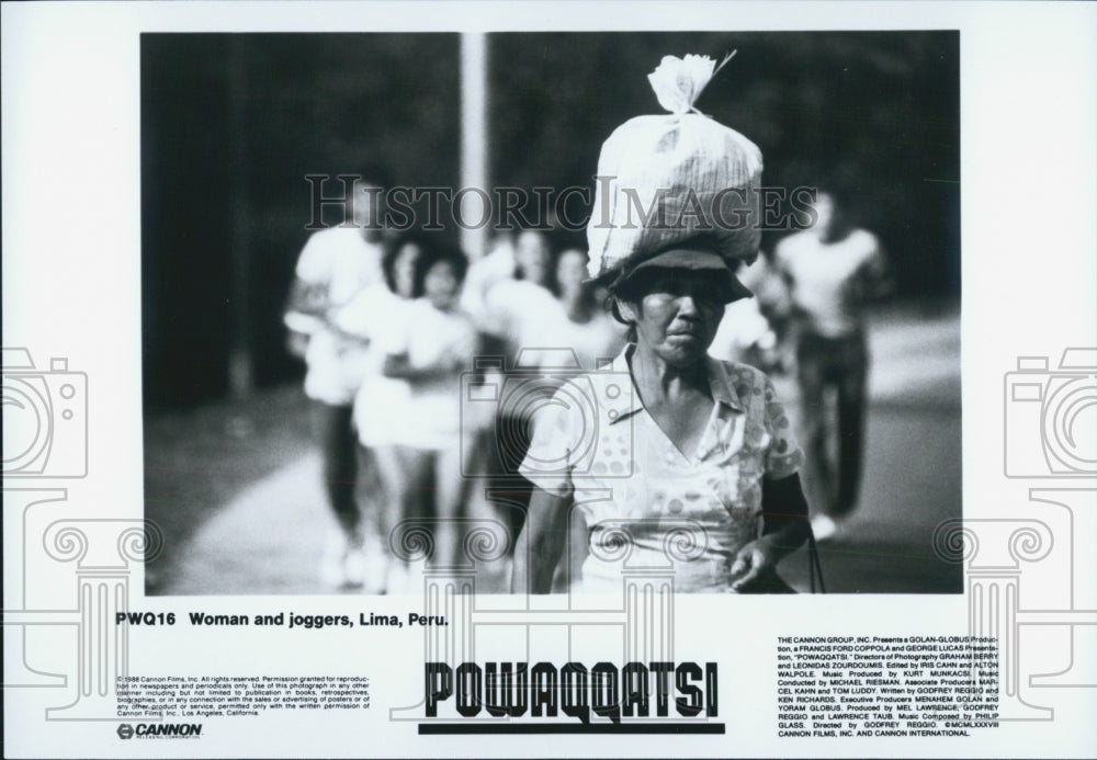 1988 Press Photo Woman and joggers,Lima,Peru,from Powaqqatsi - Historic Images