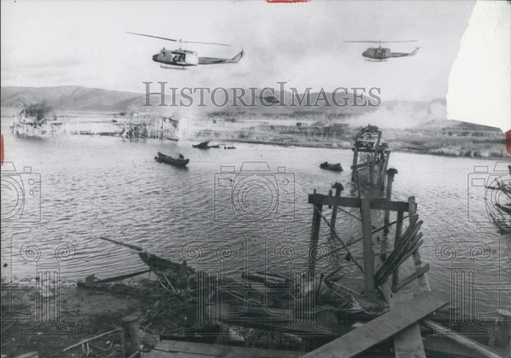 Press Photo Helicopter over watered broken bridge - Historic Images