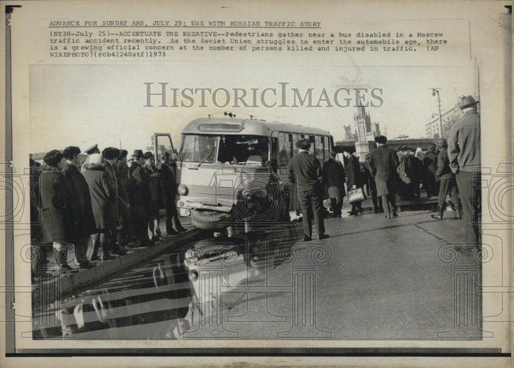 1973 Pedestrians gather near a bus involved in a traffic accident. - Historic Images