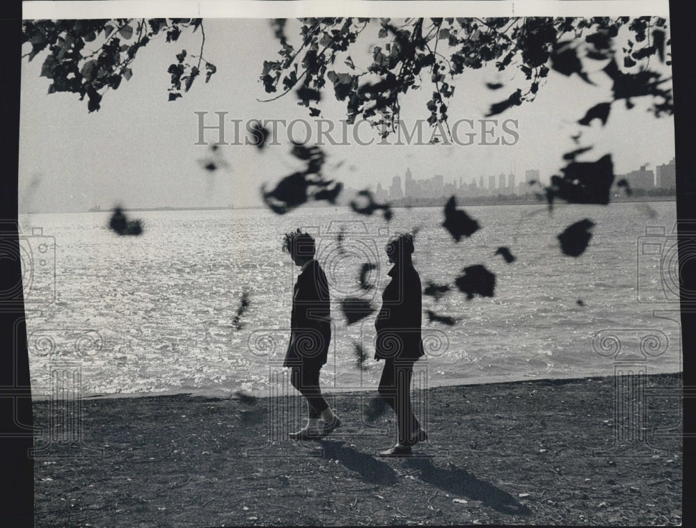 1966 Women Walk Montrose Harbor With Chicago Skyline In Back - Historic Images