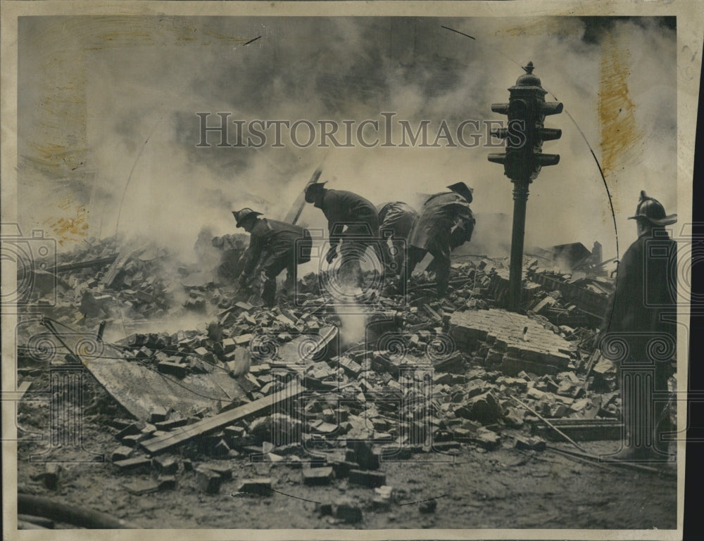 1947 Firermen looking through rubble of a Building that caught fire - Historic Images